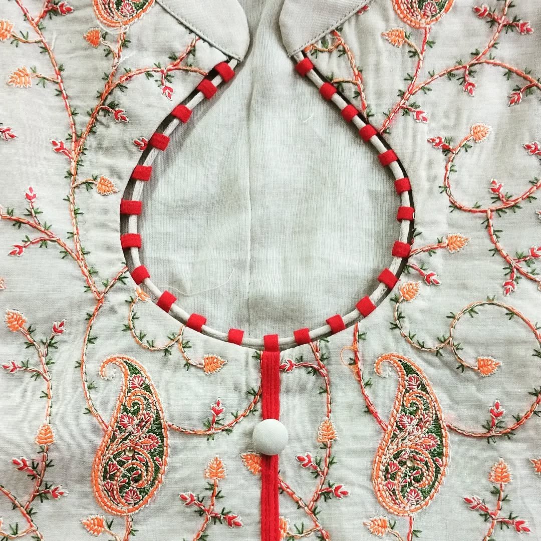 Blouse neckline in progress with red piping and paisley embroidery