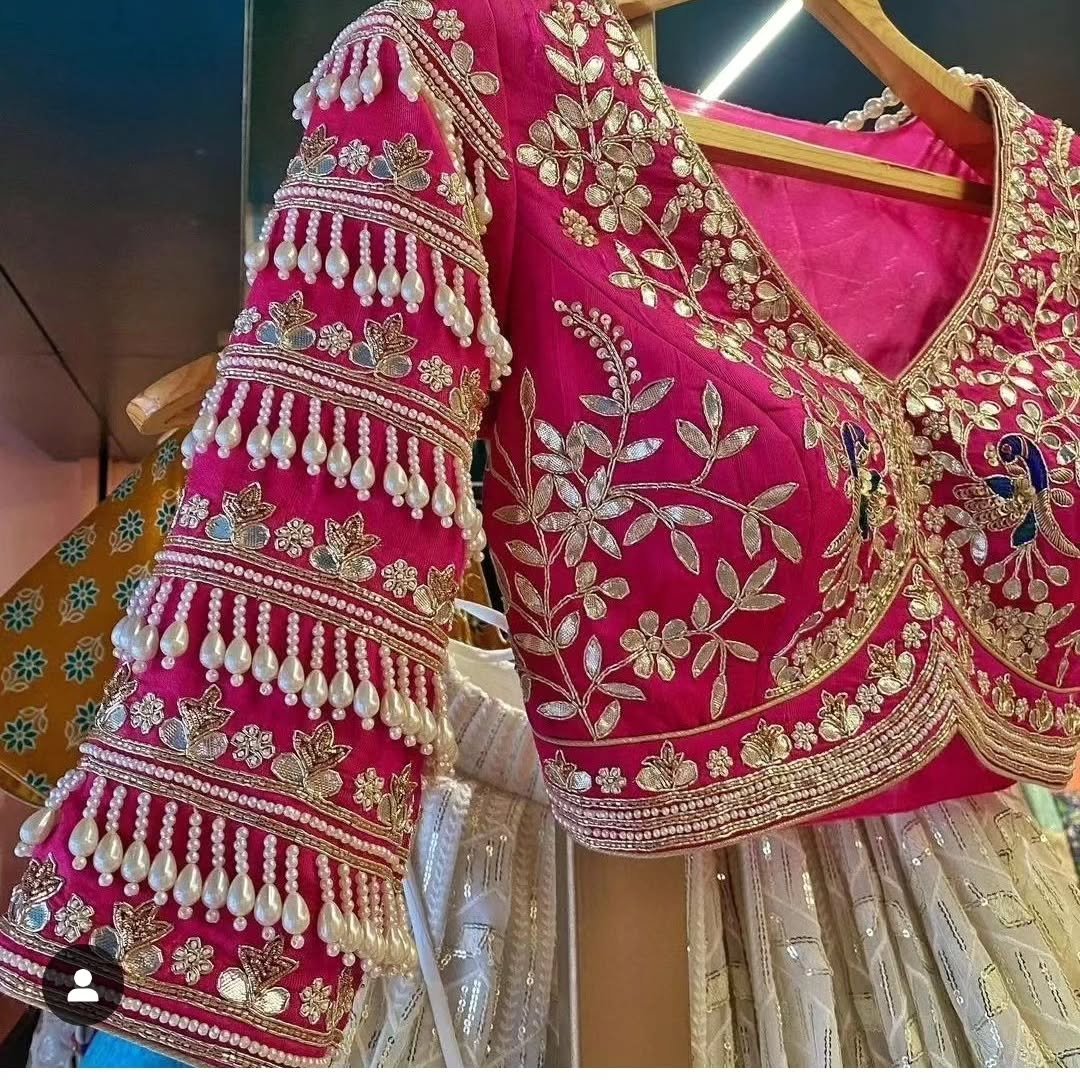 Pink blouse with pearl drape and gold floral embroidery detail
